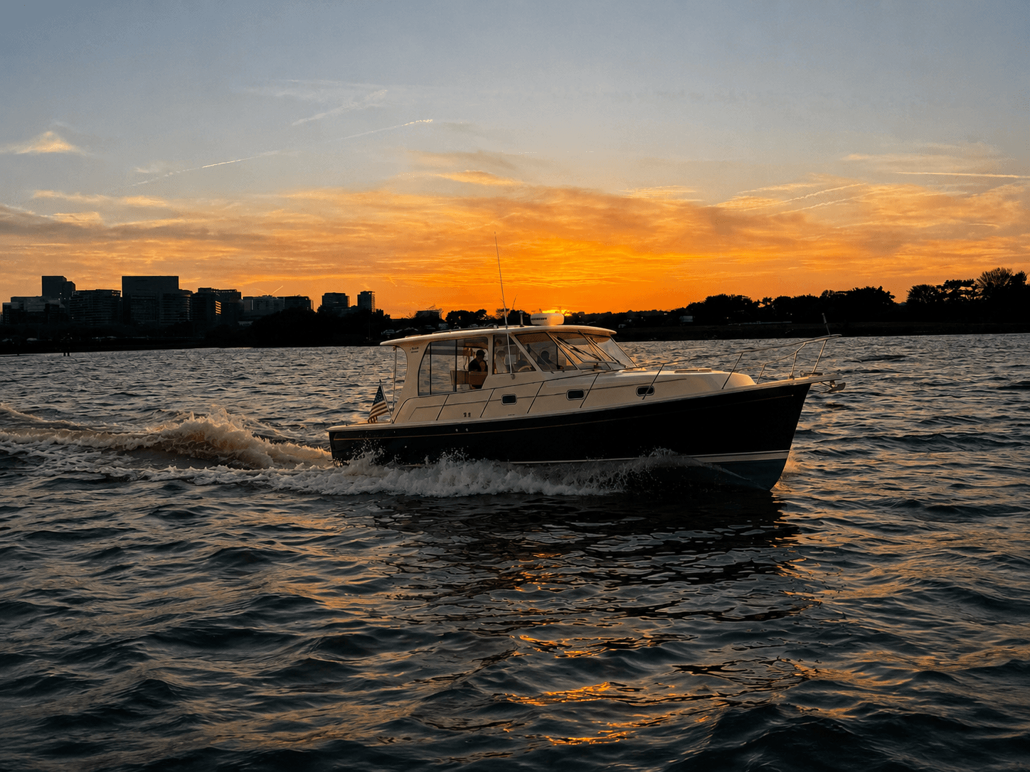 Geronimo cruising the Potomac River at sunset with the Washington skyline behind